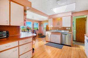 a kitchen with white cabinets and a kitchen island at Surfer's Â Landing in Westport