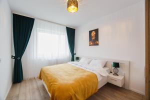a bedroom with a large bed and a window at Duet Noir in Oradea