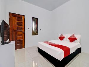 Tempat tidur dalam kamar di OYO 92054 Gala Residence