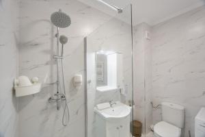 a bathroom with a shower and a toilet and a sink at Duet Noir in Oradea +22 photos