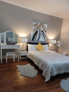a bedroom with a bed with a desk and a mirror at Gabriel Guesthouse in Rhyl