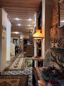 a hallway with a living room and a table with a lamp at VIRSA BOUTIQUE ROOMS in Ioannina