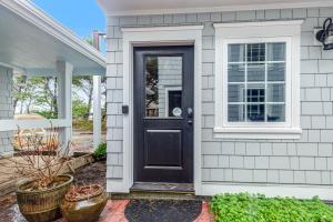 a house with a black door and a window at Ocean Delight in Warrenton