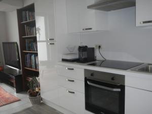 a kitchen with a counter and a sink and a stove at Ebelle Ebonne in Geluwe
