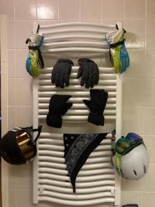 a bunch of hats and gloves hanging on a wall at Familienapartment Sonne und Schnee in Kanzelhöhe