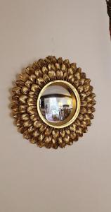 a gold mirror hanging on a ceiling at La petite Provence in Bormes-les-Mimosas