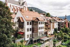 a row of buildings on a hill with a church at VillaJazz Apartments in Murau