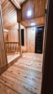 an inside view of a wooden cabin with wooden floors at Feel Funny House in Kʼveda Marghi