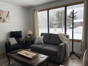 sala de estar con sofá y mesa en The North Escape Cozy 3 bedroom house Great location, en Sault Ste. Marie