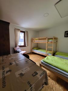 a room with two bunk beds and boxes in it at Bus Station Beds in Bled