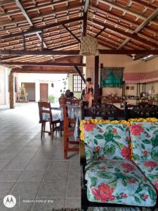 a room with a table and chairs with pillows at Pousada Sol e Verão in São Pedro da Aldeia
