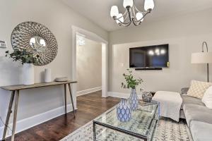 a living room with a couch and a glass table at Newark Townhome Near Airport - Pet Friendly! in Newark