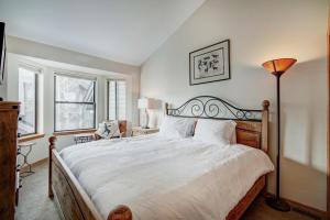 a bedroom with a large bed and a lamp at Village Point in Breckenridge