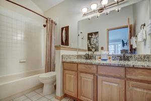 a bathroom with a sink and a toilet and a mirror at Village Point in Breckenridge +35 photos