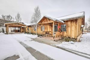 a log cabin in the snow with a driveway at Williams Vacation Rental with Mountain View! in Williams