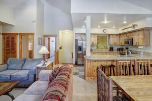 a kitchen and living room with a couch and a table at Mountain Thunder #604 in Breckenridge