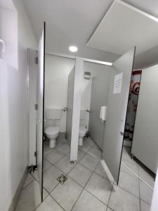 a bathroom with a toilet and a mirror in it at Bus Station Beds in Bled