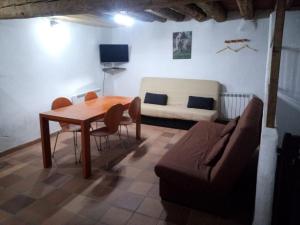 a living room with a table and a couch at Apartamento Valdelinares,Casa la roca in Valdelinares