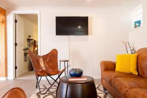 a living room with a couch and a chair at The Lagartija @ Old Town with King Bed in Albuquerque