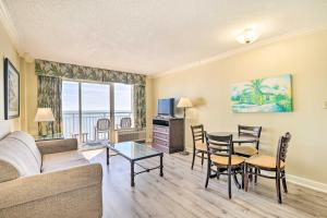 a living room with a couch and a table and chairs at Oceanfront Myrtle Beach Condo with Balcony! in Myrtle Beach