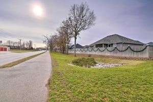 a road next to a fence and a house at Pet-Friendly Ozark Home with Yard and Patio in Ozark