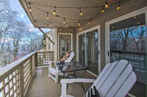 een veranda met 2 stoelen, een tafel en verlichting bij Wintergreen Resort Condo Walk to Ski Lift! in Mount Torry Furnace
