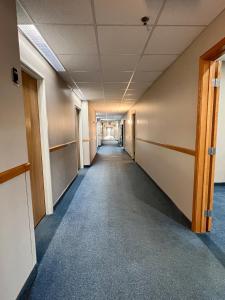 an empty hallway in an office building at Reston Inn & Suites in Spencer