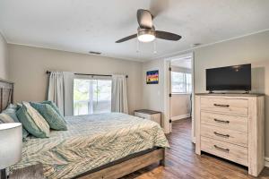 a bedroom with a bed and a flat screen tv at Pet-Friendly Gulfport Home Less Than 2 Mi to Beach in St Petersburg