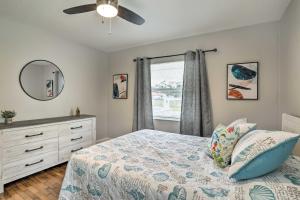 a bedroom with a bed and a dresser and a window at Pet-Friendly Gulfport Home Less Than 2 Mi to Beach in St Petersburg