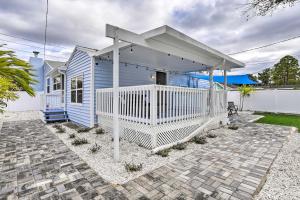 a blue house with a white porch at Pet-Friendly Gulfport Home Less Than 2 Mi to Beach in St Petersburg