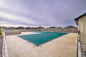 a tennis court in the middle of a yard at Charming Ozark Abode with Yard and Pool Access in Ozark