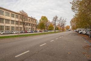 een lege straat met auto's aan de zijkant van een gebouw bij Cappella degli Scrovegni Grey Apartment in Padua
