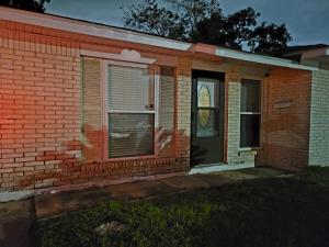 a brick house with a door and a window at Large Spacious Bedroom with Private Entrance Females Only in Westwego