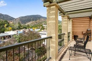 a balcony with chairs and a view of the mountains at The Owl's Nest @ Manitou: Mtn Views on Main Street in Manitou Springs