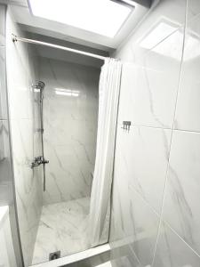 a bathroom with a shower with a shower curtain at Classic 2 Bedroom Apartment Next to Metro - Marousi in Athens