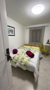 a bedroom with two beds and a yellow chair at T&S ROOM in Budva