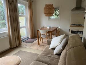 a living room with a couch and a table at Apartment Ella with free privat parking in Zandvoort