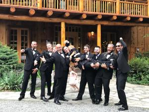 a group of men in suits posing for a picture in front of a building at The Lindsay Lodge in Applegate
