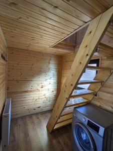 a sauna with a washing machine in a wooden house at Cottage Caucasus in Kazbegi