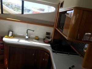 a kitchen with a sink and a window at yatch for rent izmir cesme 3 camaras kiralik yat in Ildır