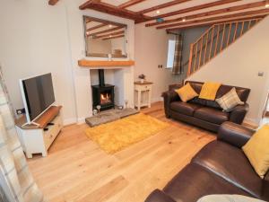 a living room with a couch and a fireplace at Appletree Cottage in Scarborough