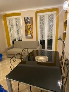 a living room with a table and a couch at Casa Orefici, 4 Apartments in front of Aquarium! in Genova