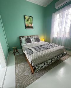 a bedroom with a bed in a green wall at Avalon II in Innisfail