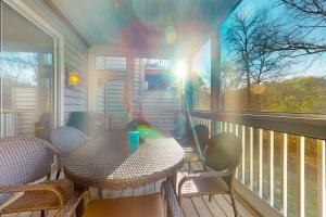 a patio with a table and chairs on a porch at Salt Pond --- 31962 Topsail Court Unit 7 in Bethany Beach