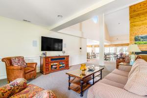 a living room with two couches and a tv at Salt Pond --- 31962 Topsail Court Unit 7 in Bethany Beach