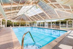 a large swimming pool with a glass ceiling at Salt Pond --- 31962 Topsail Court Unit 7 in Bethany Beach