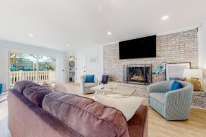 a living room with a couch and a fireplace at Town of South Bethany --- 108 Brandywine Dr in Bethany Beach