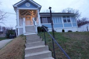 a blue house with stairs in front of it at Handsome Home - 4 minutes close to Metro in Lanham