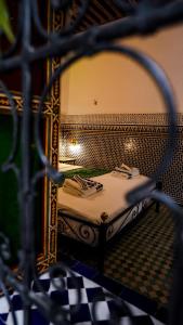 a view of a bedroom with a bed with a mirror at Riad Green House in Fès