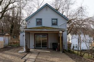 a house with a front porch and a driveway at Cozy & Comfy Cottage in the City - w parking in Pittsburgh